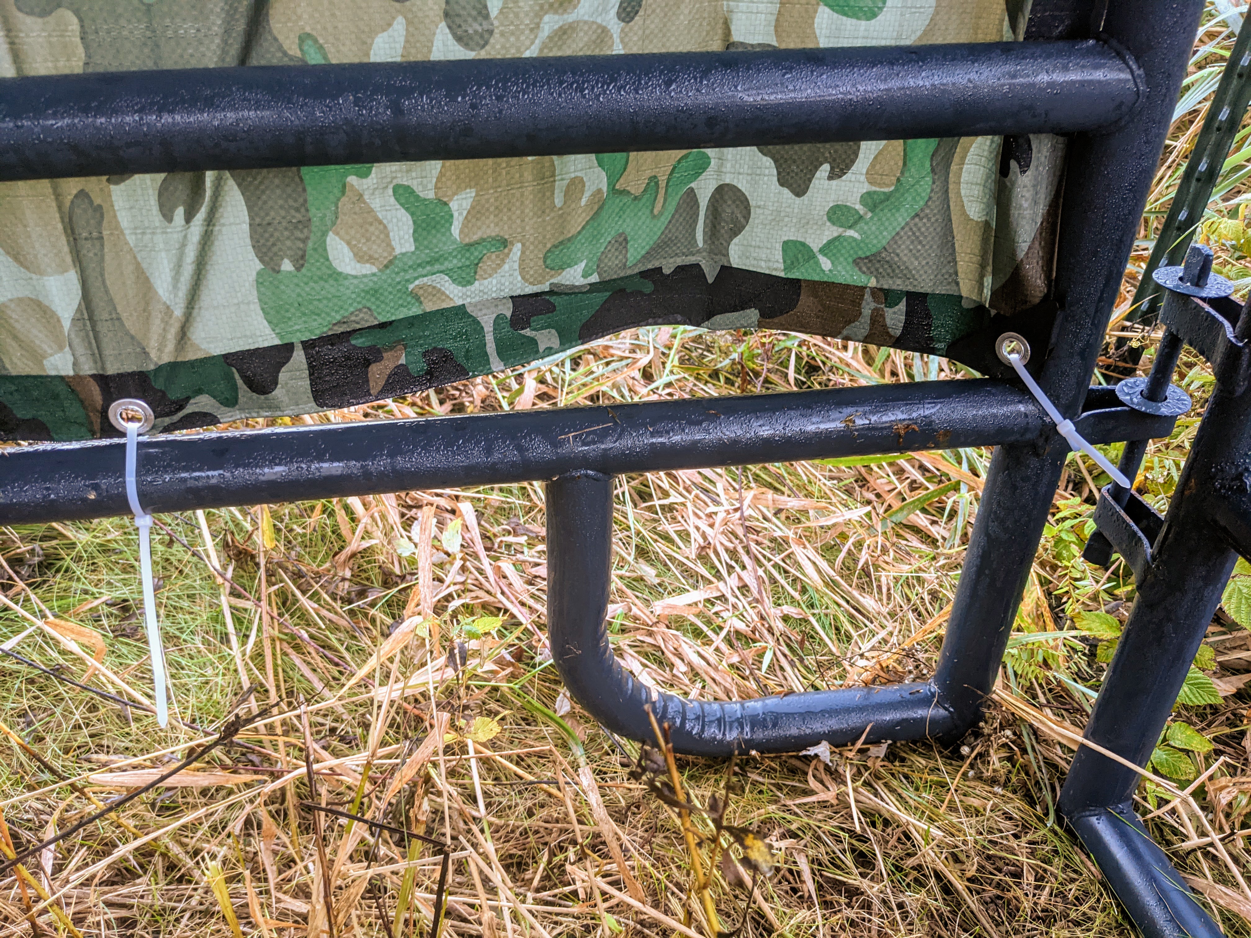 Rear tarp tied to the bottom rung of the back corral panel